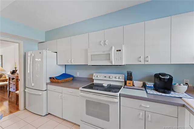 a kitchen with cabinets appliances and a counter space