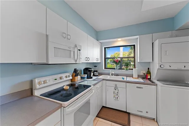 a kitchen that has a sink and a stove in it