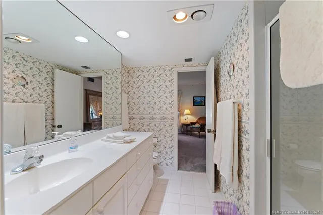 a bathroom with a double vanity sink mirror and shower