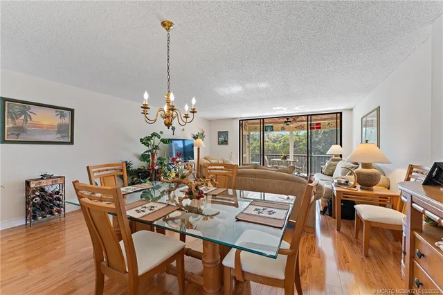 a view of a dining room with furniture wooden floor and chandelier