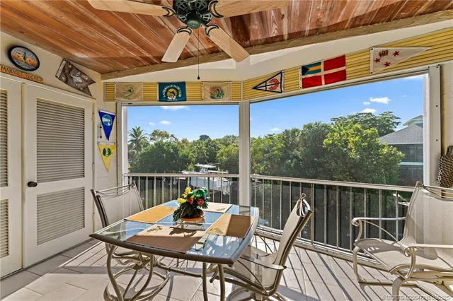 a view of a chairs and table in the balcony