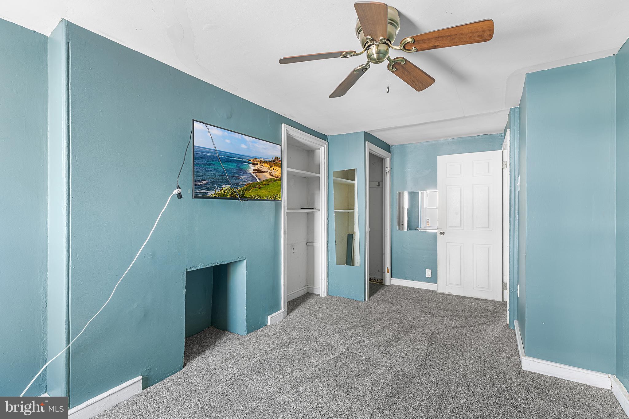 157 Cotton Street Philadelphia, PA 19127 - Photo 13 of 26 a view of a livingroom with a ceiling fan a fireplace and a ceiling fan