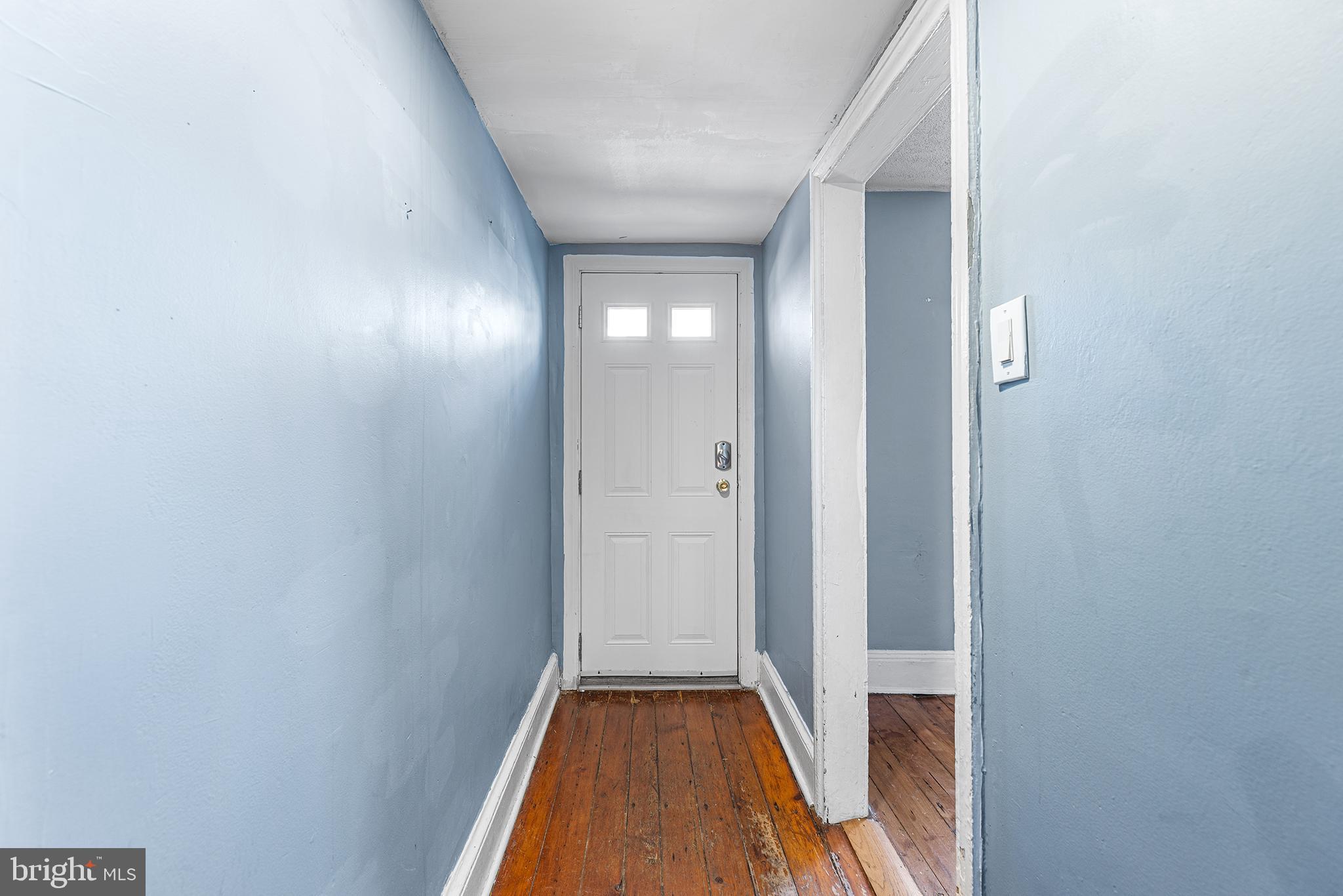157 Cotton Street Philadelphia, PA 19127 - Photo 2 of 26 a view of a hallway with wooden floor and a bathroom
