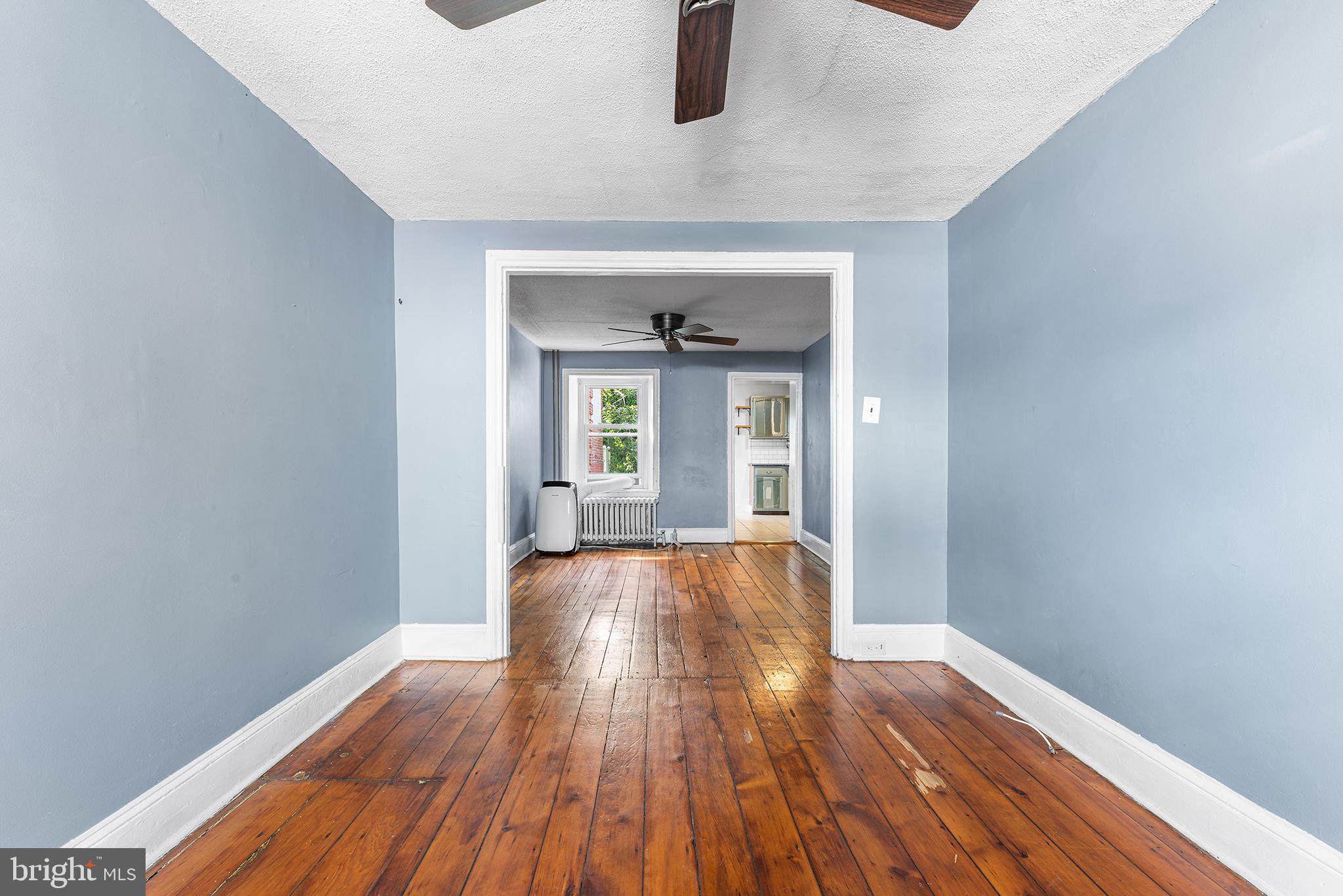 157 Cotton Street Philadelphia, PA 19127 - Photo 3 of 26 a view of an empty room with wooden floor and a window