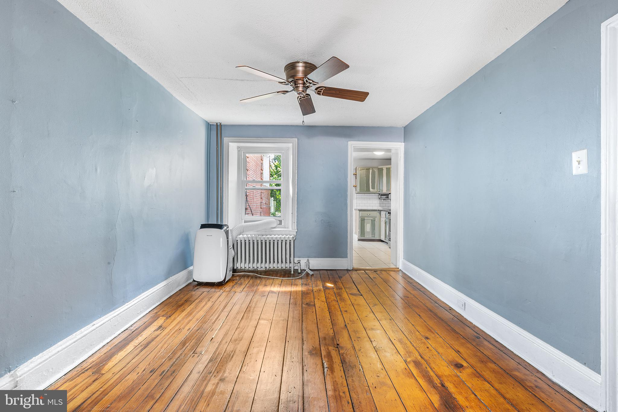 157 Cotton Street Philadelphia, PA 19127 - Photo 5 of 26 a view of empty room with wooden floor and fan