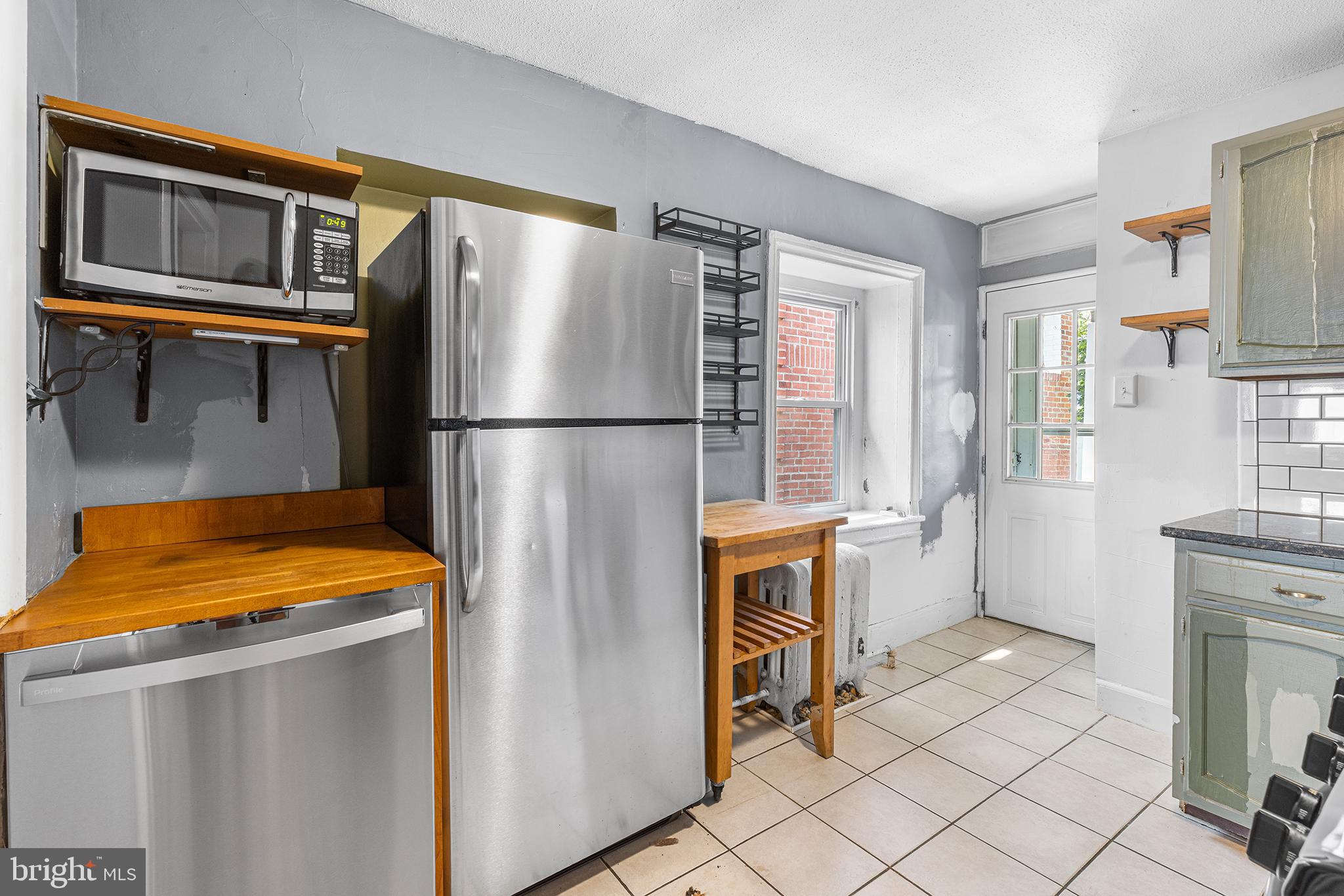 157 Cotton Street Philadelphia, PA 19127 - Photo 9 of 26 a kitchen with stainless steel appliances granite countertop a refrigerator a stove and a sink