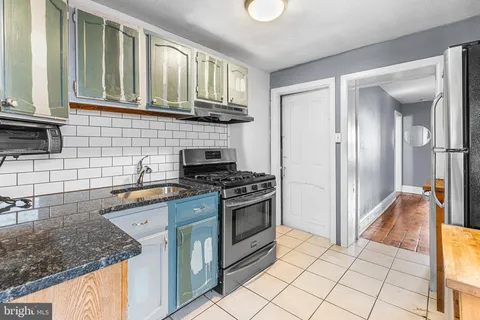 a kitchen with stainless steel appliances granite countertop a stove and a sink