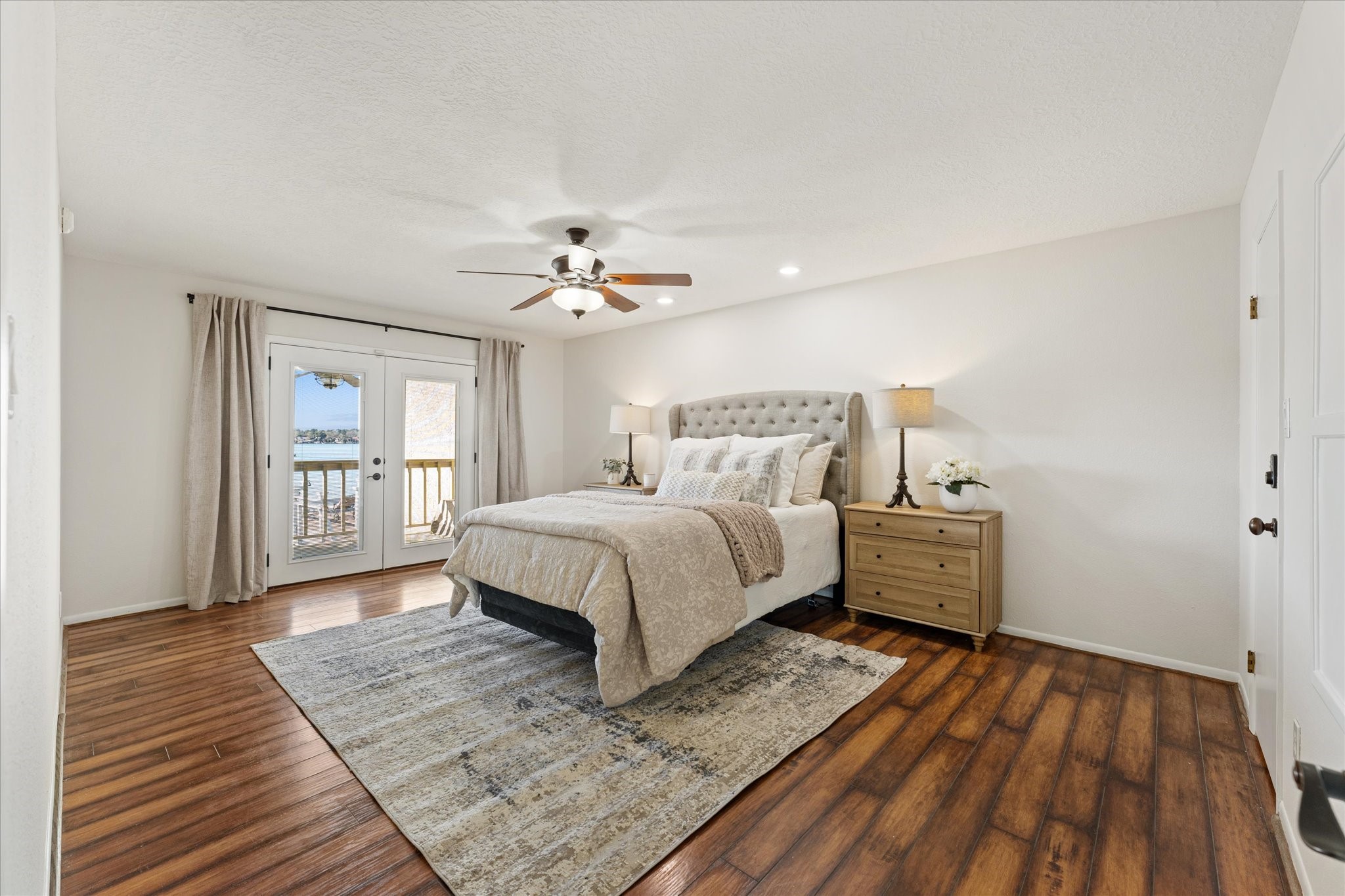145 Capetown Way Conroe, TX 77356 - Photo 13 of 38 a spacious bedroom with a bed and wooden floor