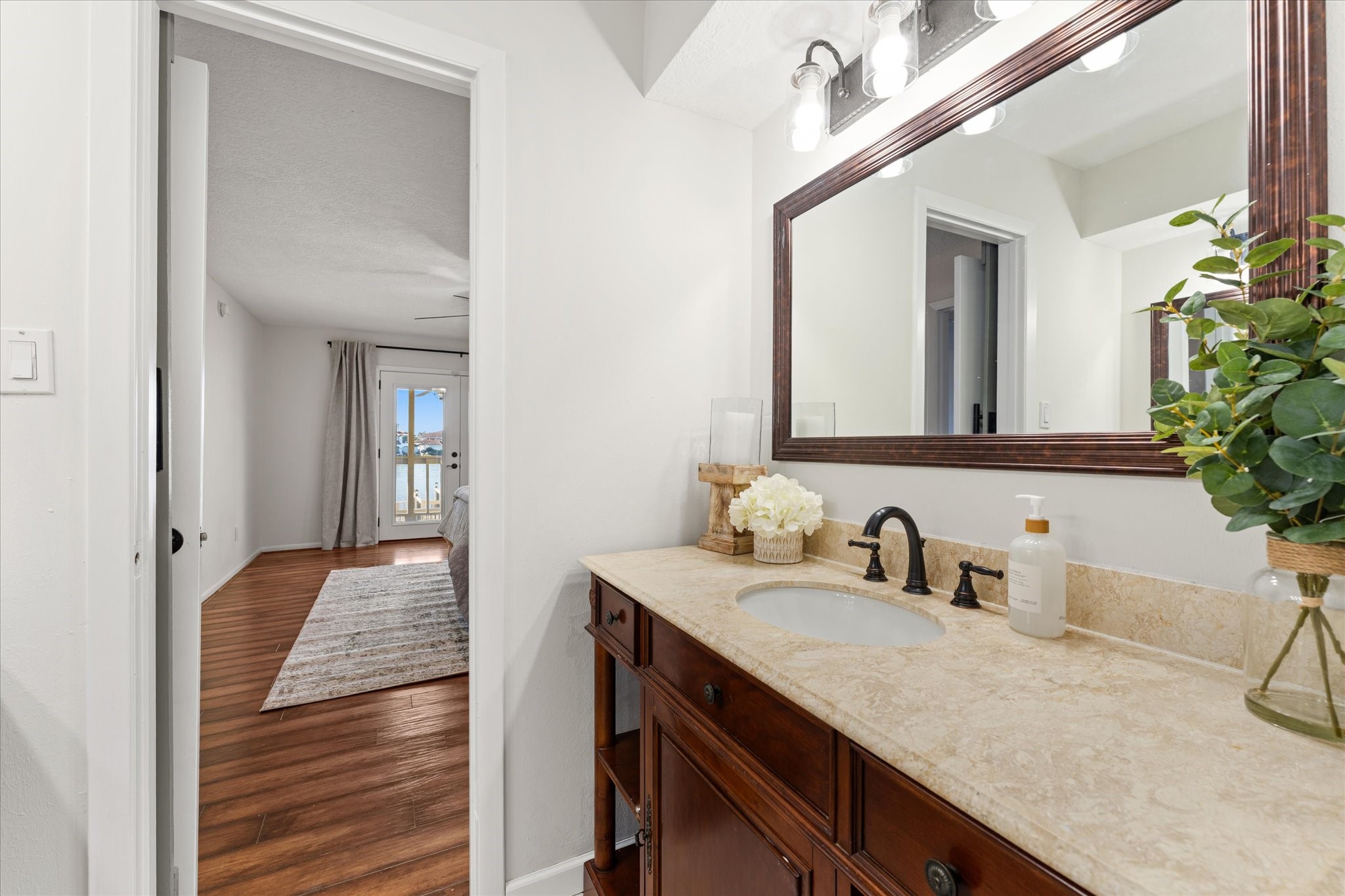 145 Capetown Way Conroe, TX 77356 - Photo 14 of 38 a en suite bathroom with a sink and mirror