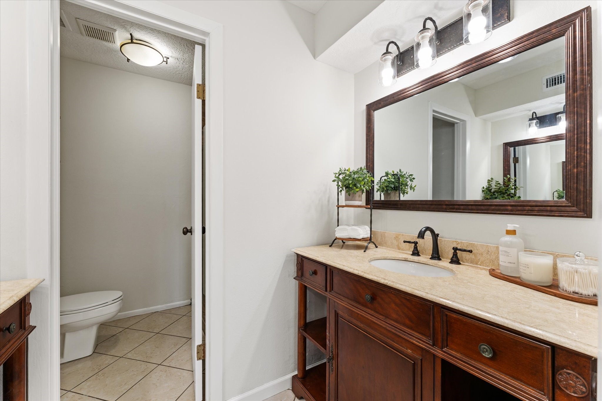 145 Capetown Way Conroe, TX 77356 - Photo 15 of 38 a bathroom with a toilet sink and mirror