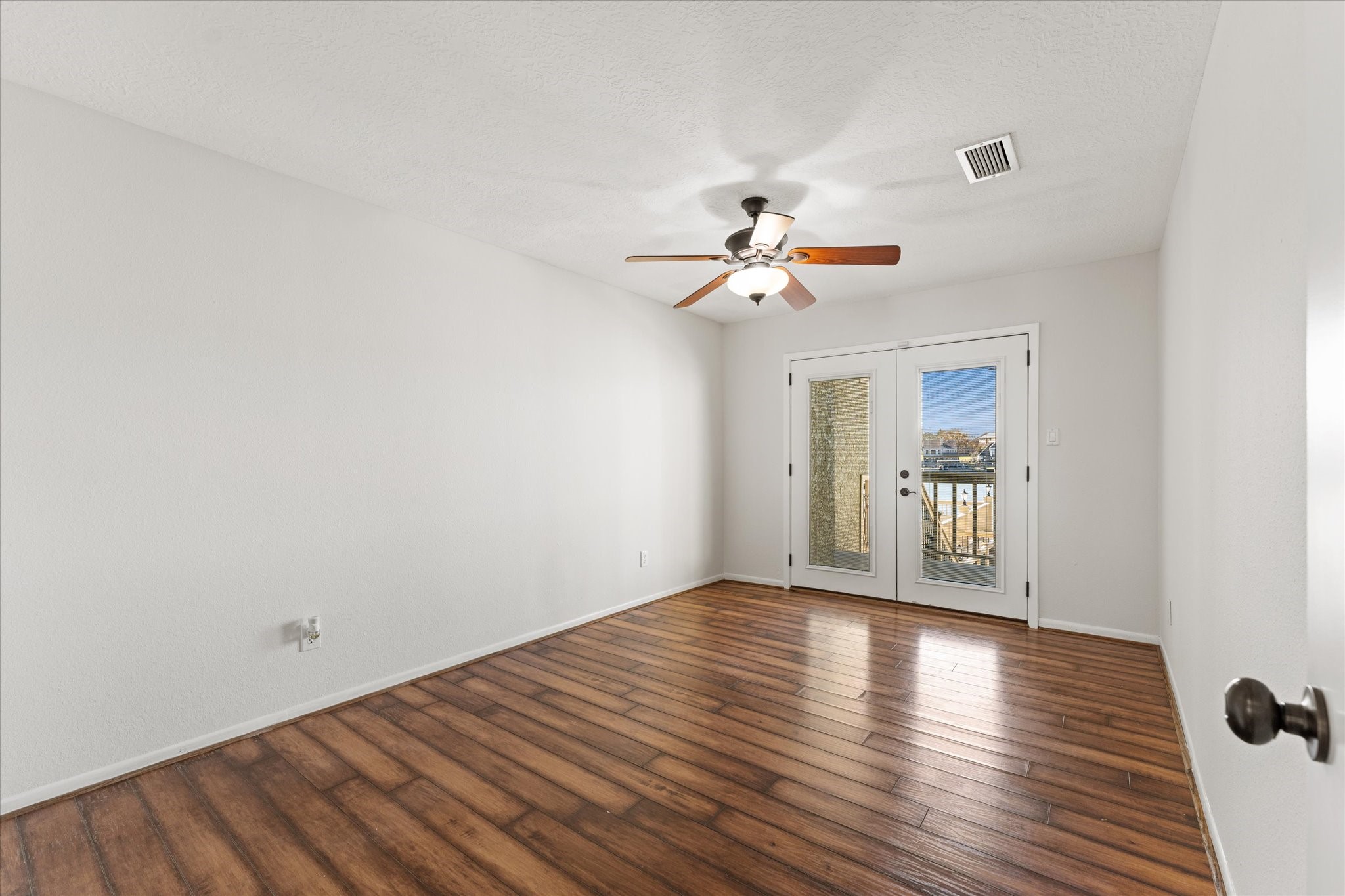 145 Capetown Way Conroe, TX 77356 - Photo 20 of 38 a view of an empty room with wooden floor