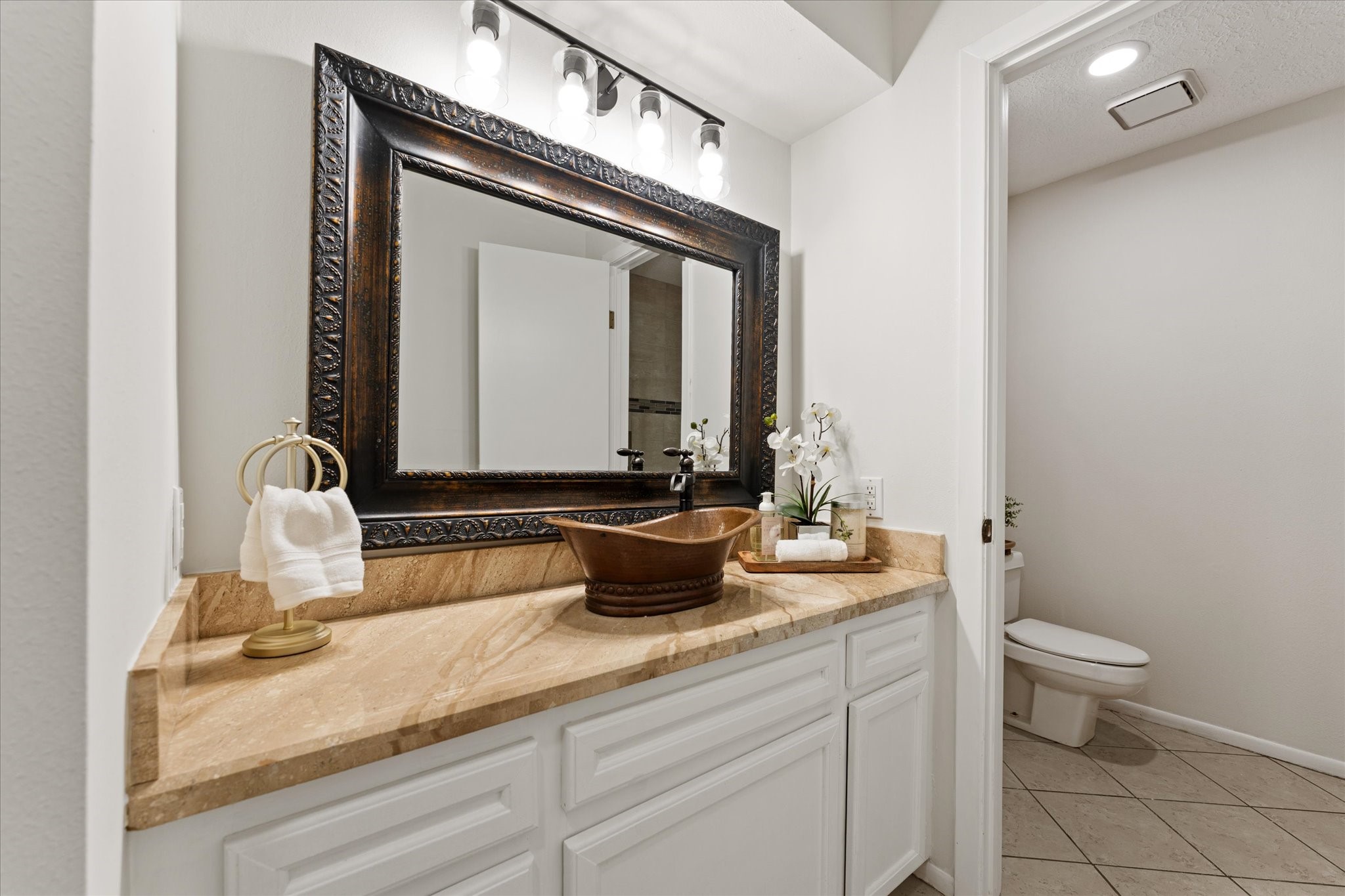 145 Capetown Way Conroe, TX 77356 - Photo 21 of 38 a bathroom with a granite countertop sink and a mirror