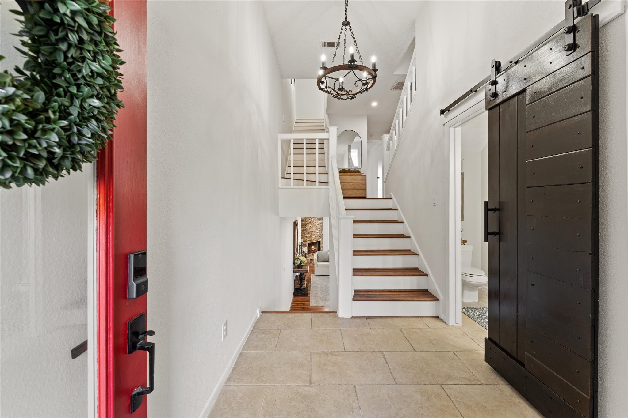 145 Capetown Way Conroe, TX 77356 - Photo 3 of 38 a view of a hallway with stairs and chandelier