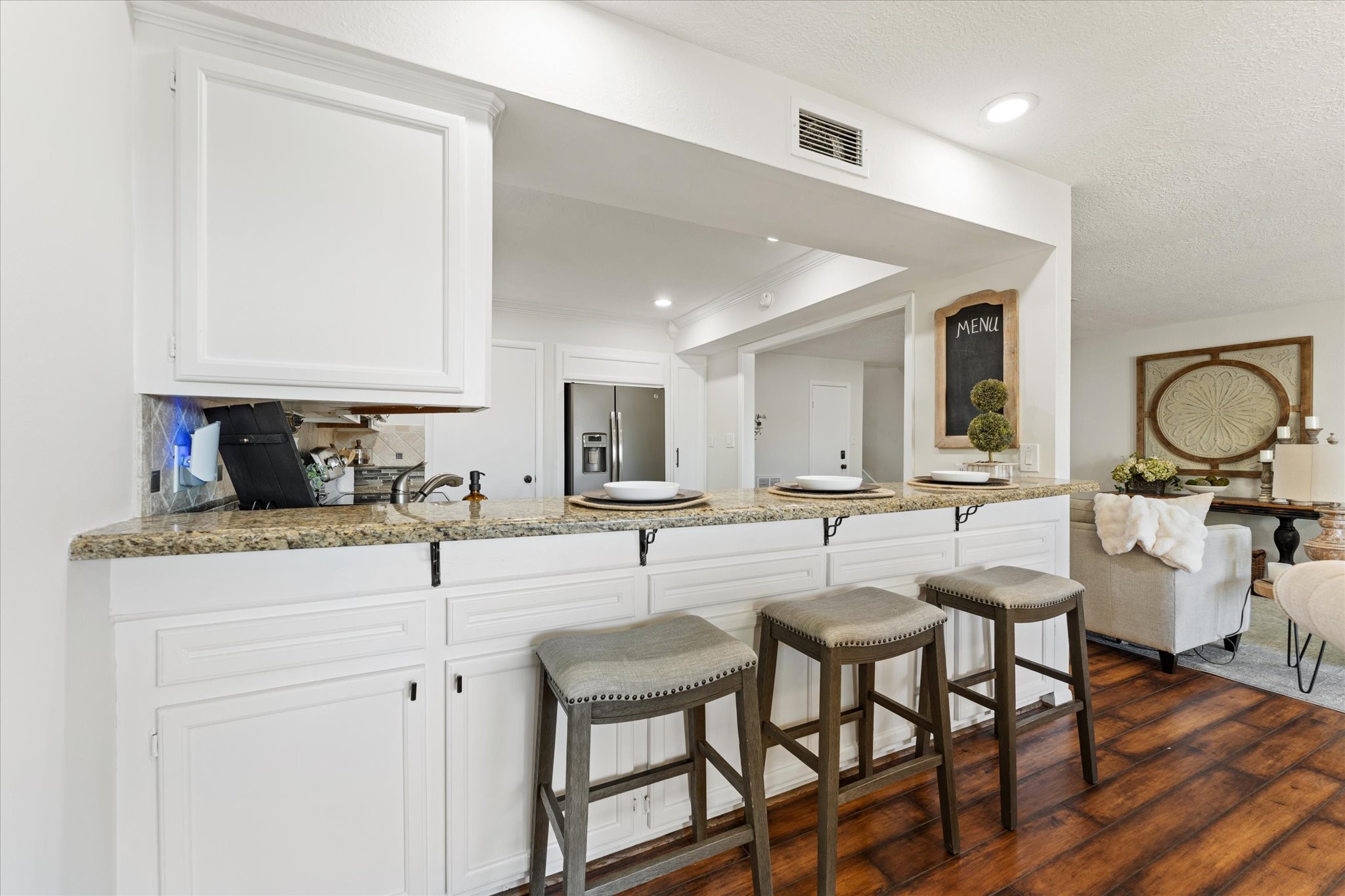 145 Capetown Way Conroe, TX 77356 - Photo 8 of 38 a kitchen with stainless steel appliances granite countertop a table chairs sink and cabinets