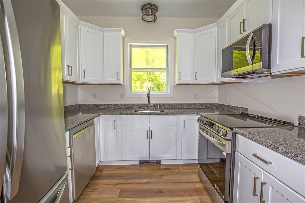 165 Sandisfield Road Sandisfield, MA 01255 - Photo 10 of 37 a kitchen with stainless steel appliances granite countertop a sink stove and cabinets