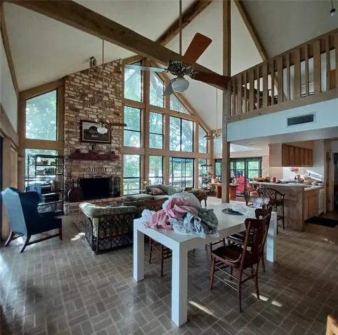 a view of a livingroom with furniture window and a fireplace