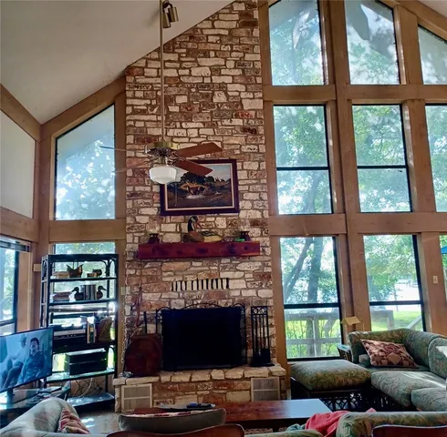 a living room with furniture a fireplace and windows
