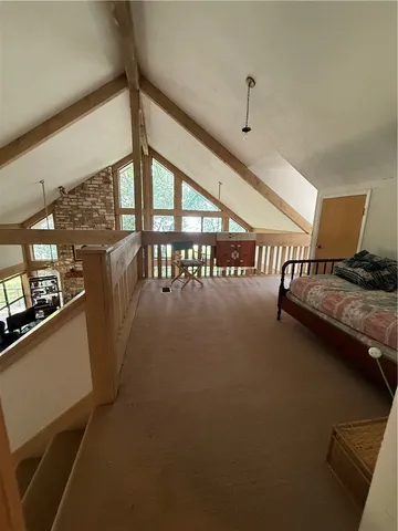 a living room with furniture a fireplace and a floor to ceiling window