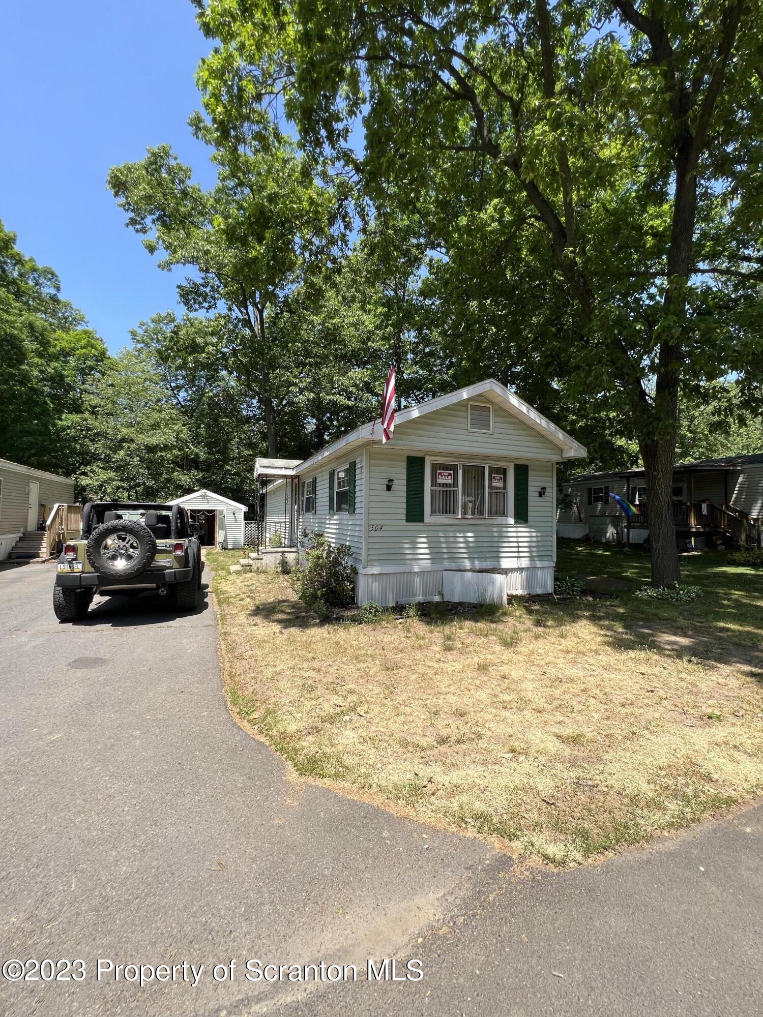 504 5th Street Avoca, PA 18641 - Photo 1 of 8 a front view of a house with yard covered with trees
