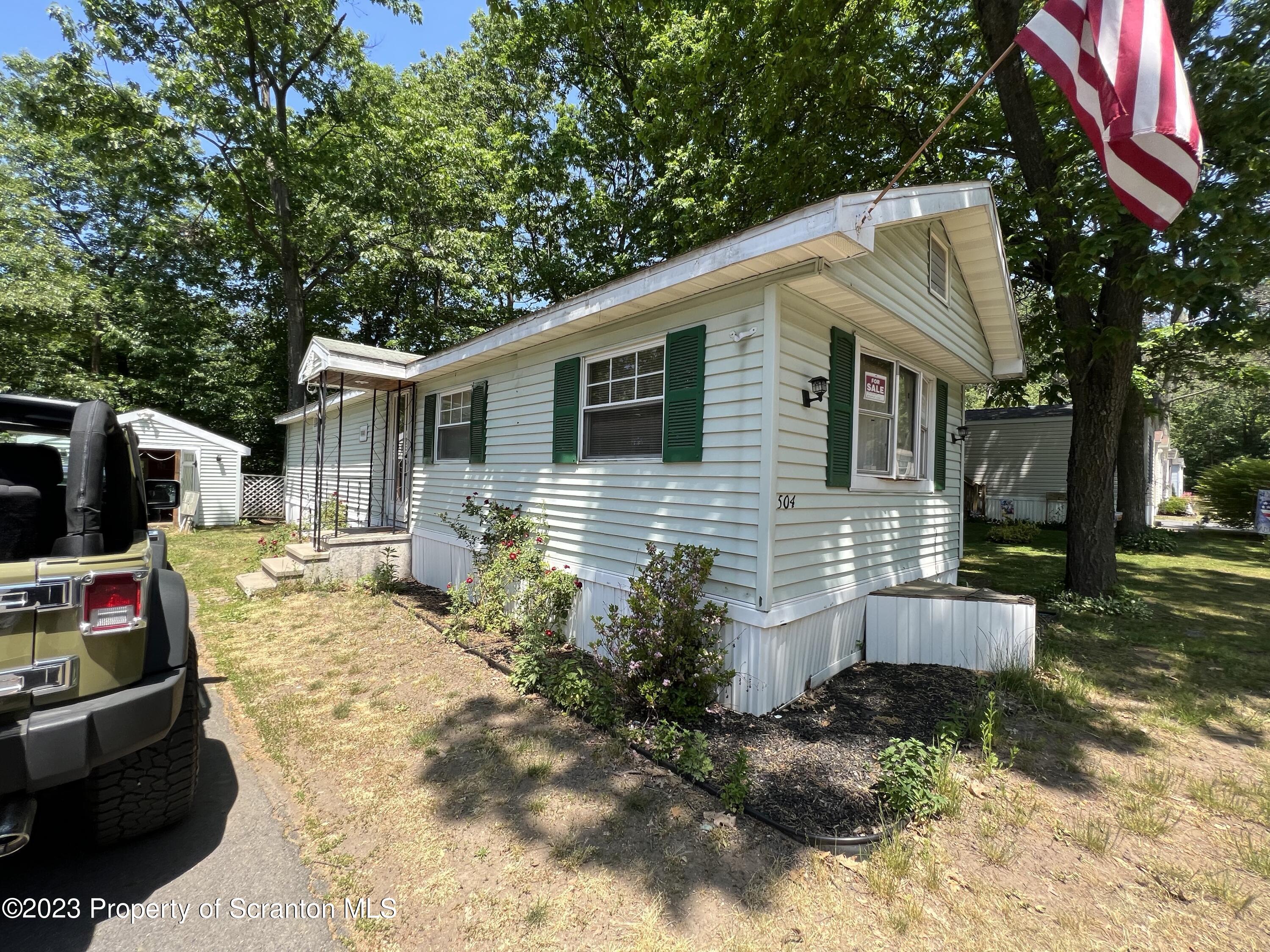 504 5th Street Avoca, PA 18641 - Photo 2 of 8 a backyard of a house with yard and outdoor seating