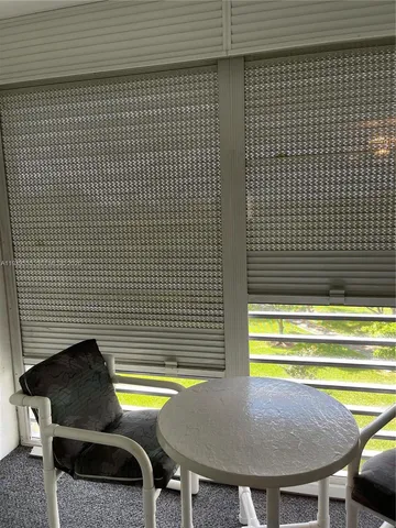 a view of a swimming pool with a table and chairs
