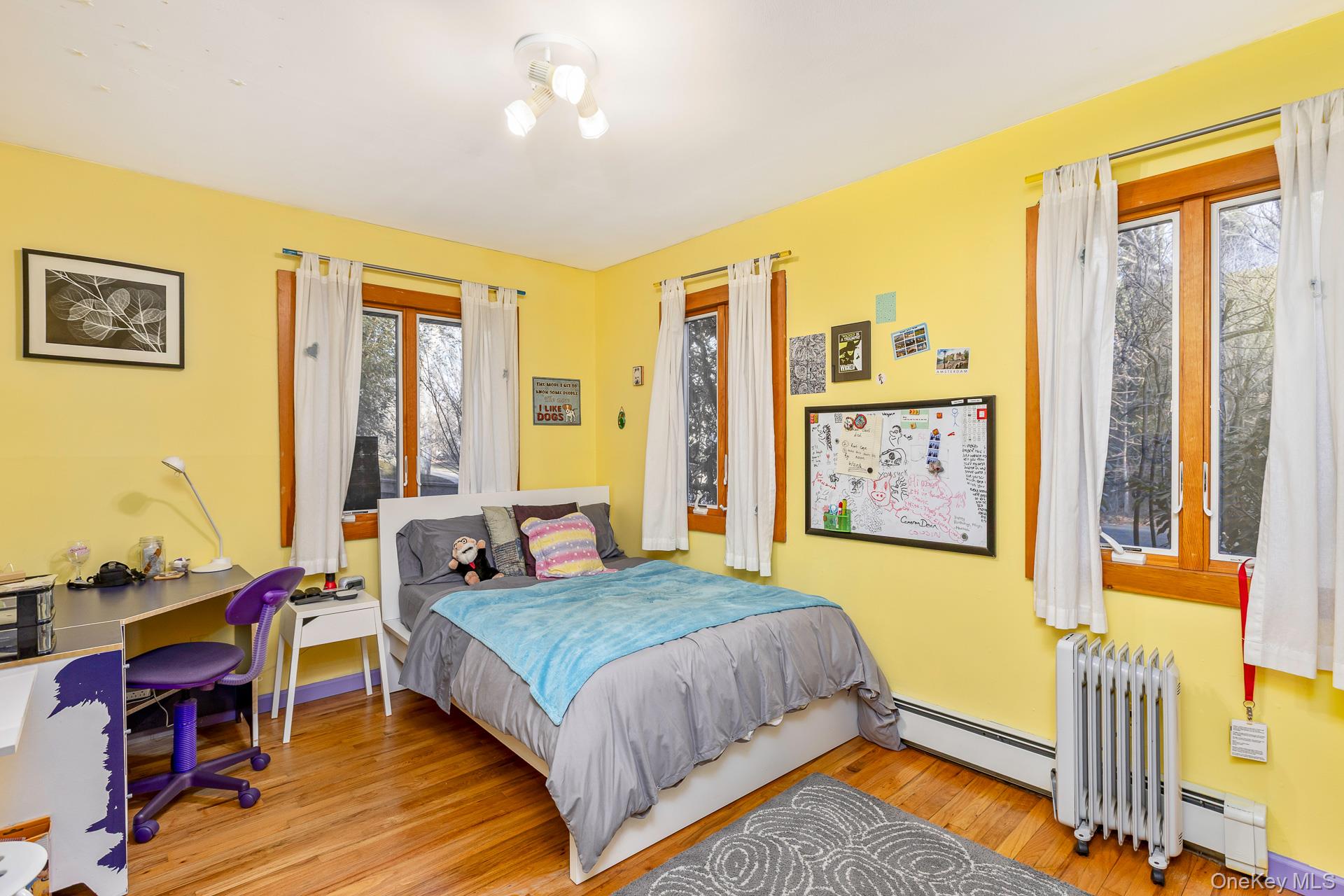 1 Cumberland Path Setauket, NY 11733 - Photo 13 of 29 a bedroom with a bed and wooden floor