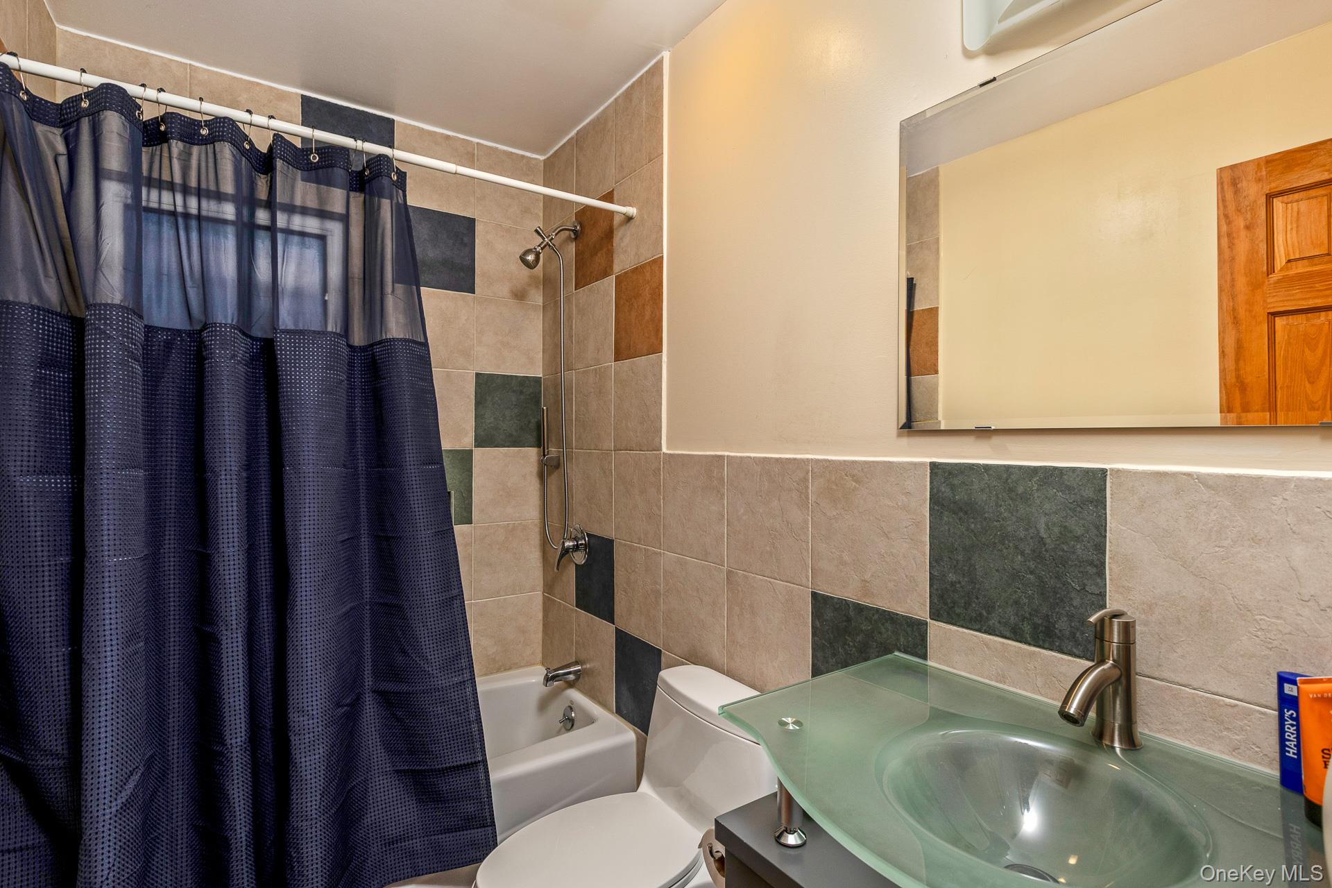 1 Cumberland Path Setauket, NY 11733 - Photo 16 of 29 a bathroom with a sink toilet and shower