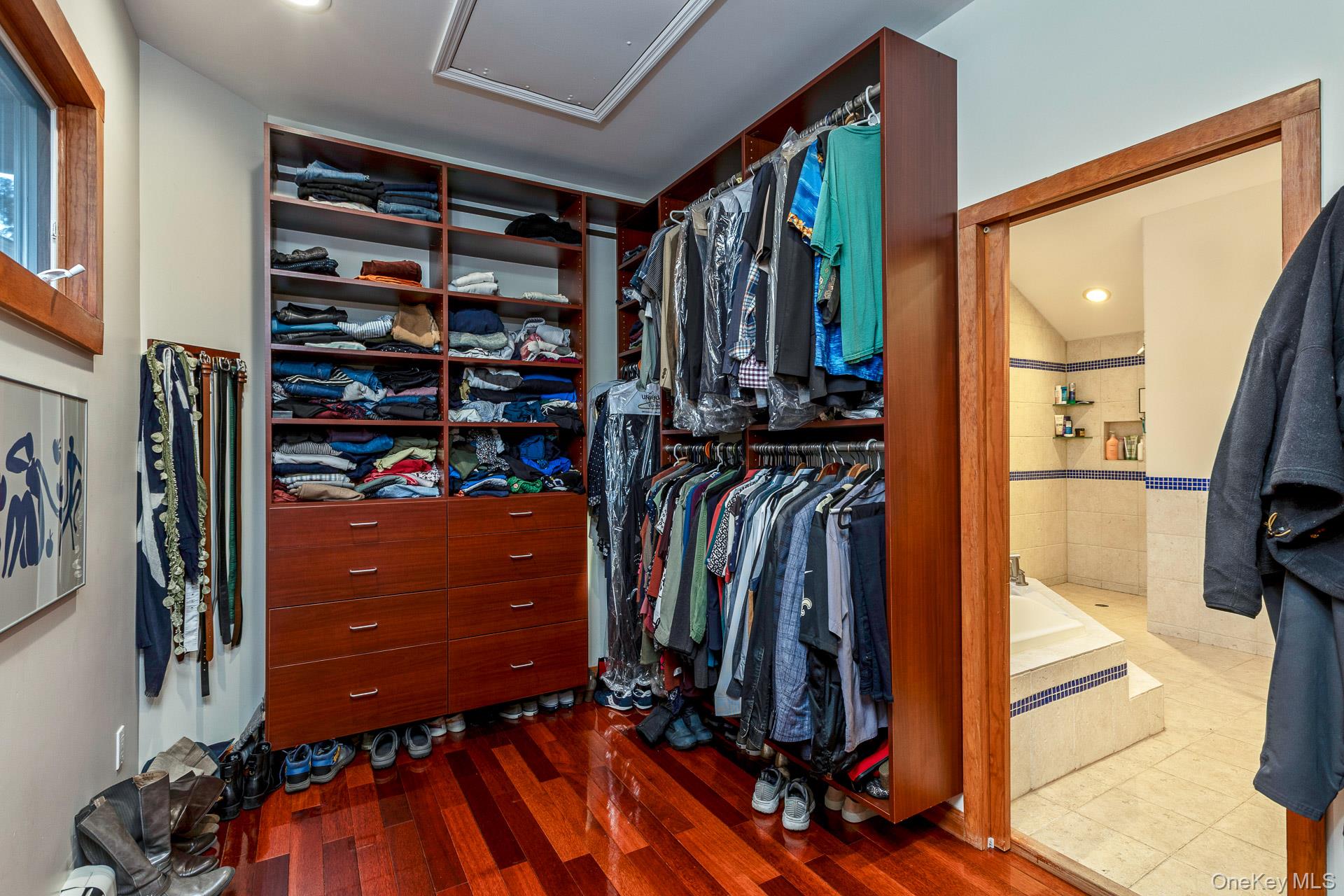 1 Cumberland Path Setauket, NY 11733 - Photo 18 of 29 a view of walk in closet with clothes and shoes