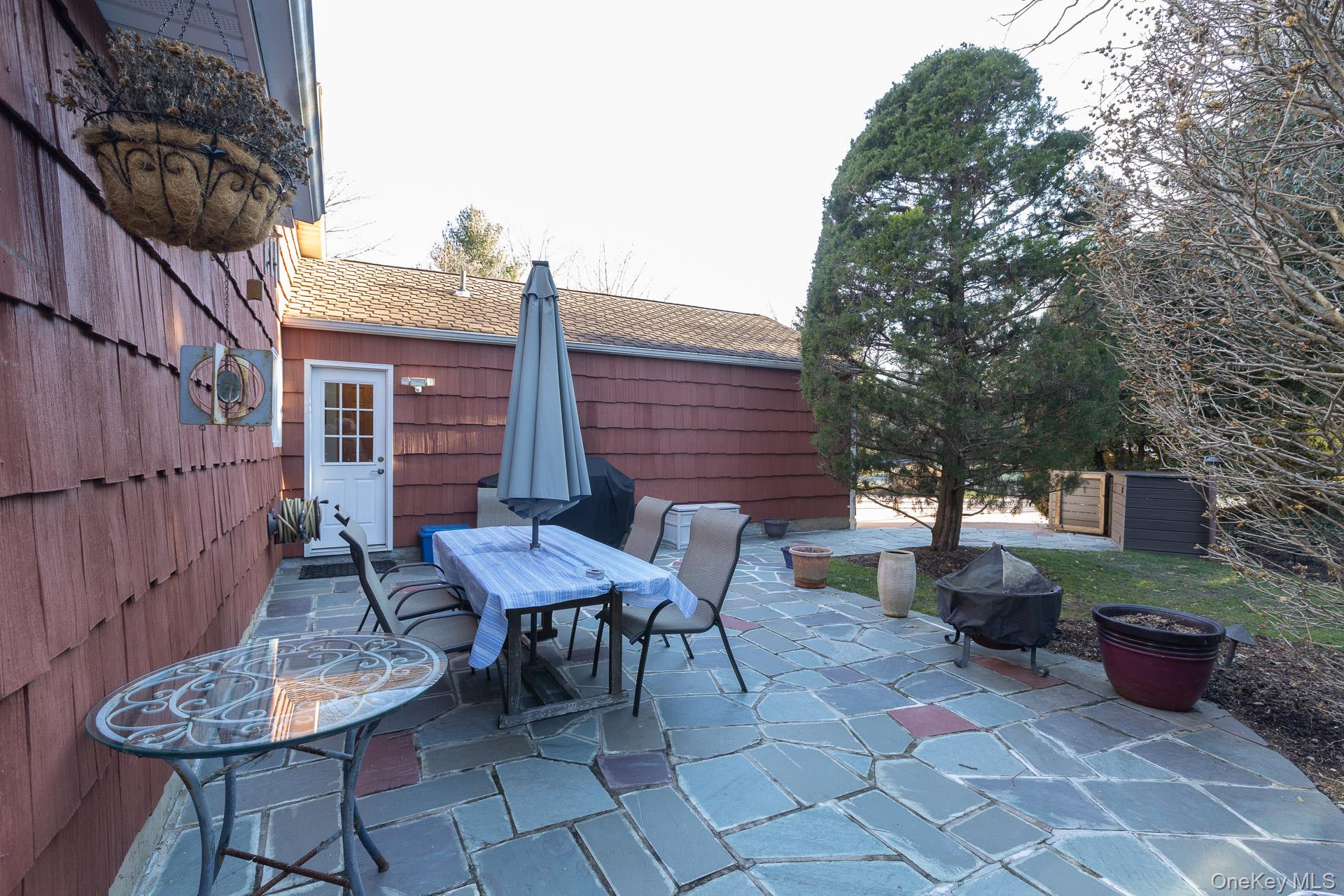 1 Cumberland Path Setauket, NY 11733 - Photo 19 of 29 a backyard of a house with table and chairs