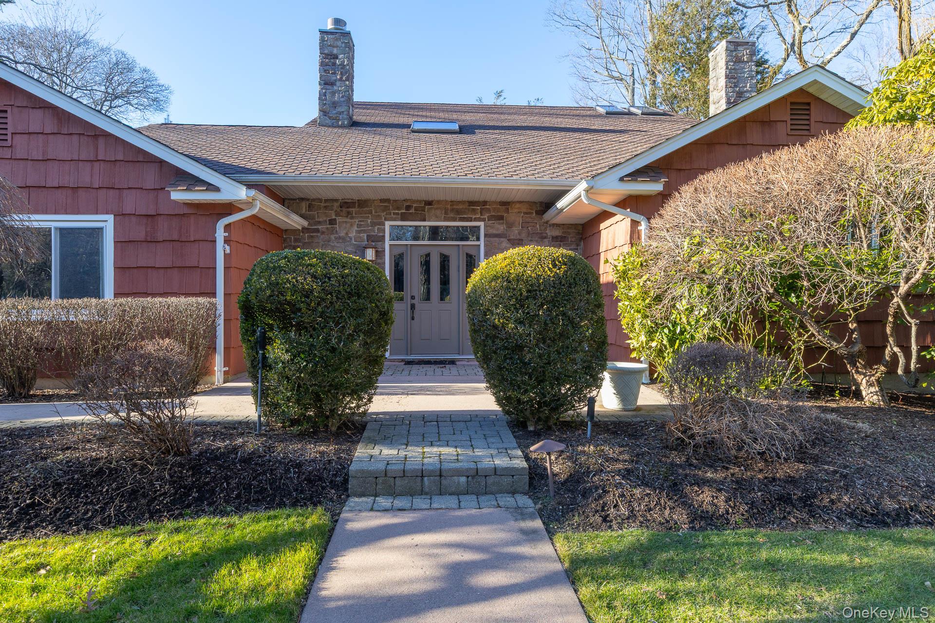 1 Cumberland Path Setauket, NY 11733 - Photo 21 of 29 a front view of a house with garden