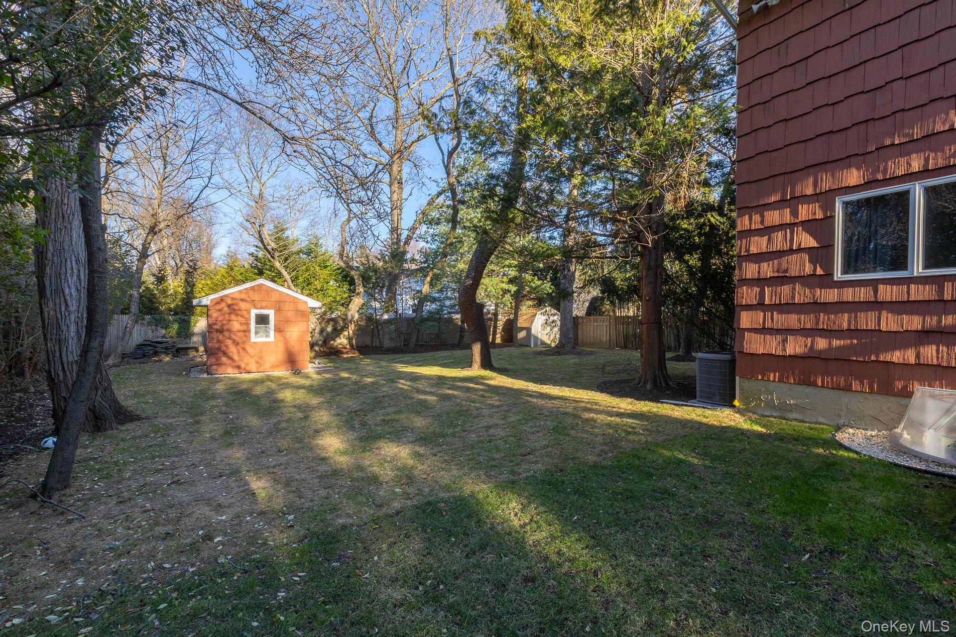 1 Cumberland Path Setauket, NY 11733 - Photo 25 of 29 a backyard of a house with lots of green space