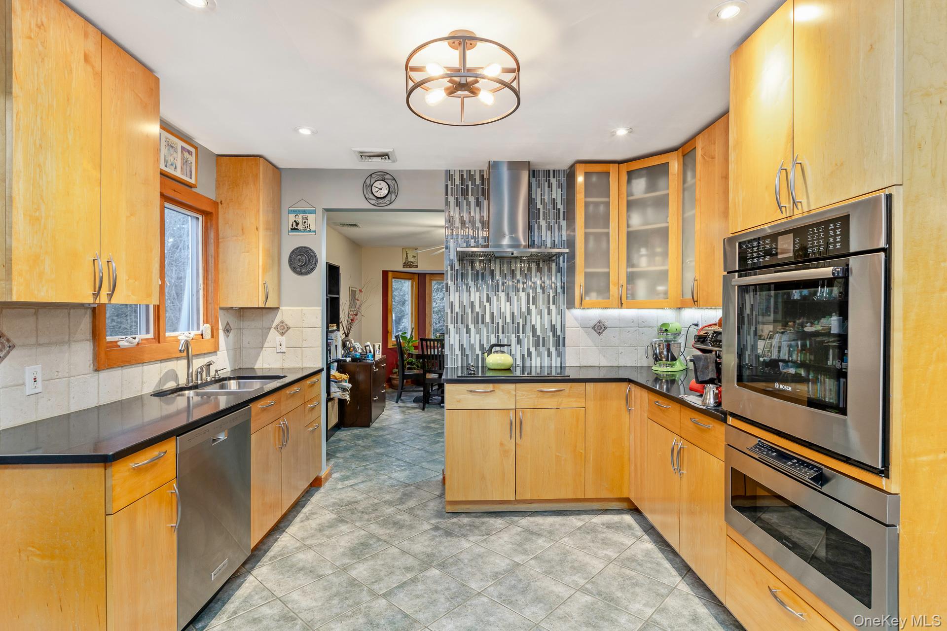 1 Cumberland Path Setauket, NY 11733 - Photo 4 of 29 a large kitchen with stainless steel appliances granite countertop a stove a sink and a microwave