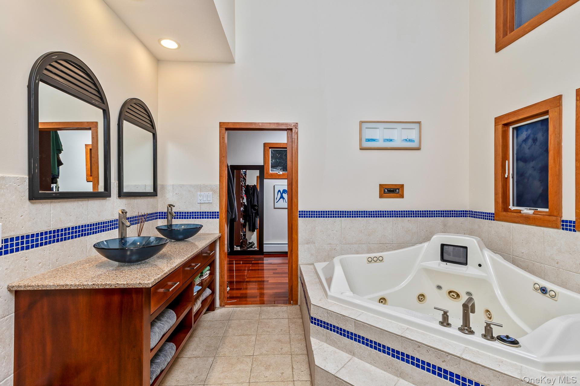 1 Cumberland Path Setauket, NY 11733 - Photo 6 of 29 a bathroom with a bathtub and a mirror