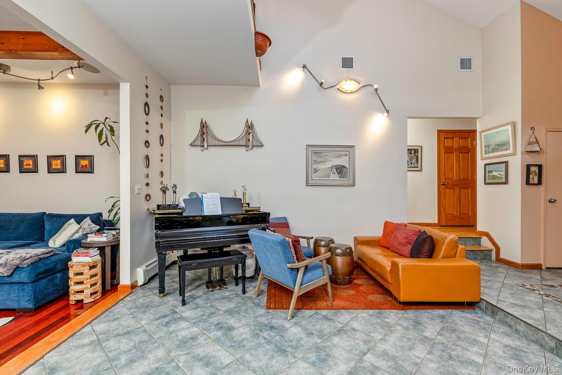 1 Cumberland Path Setauket, NY 11733 - Photo 8 of 29 a living room with furniture and a piano
