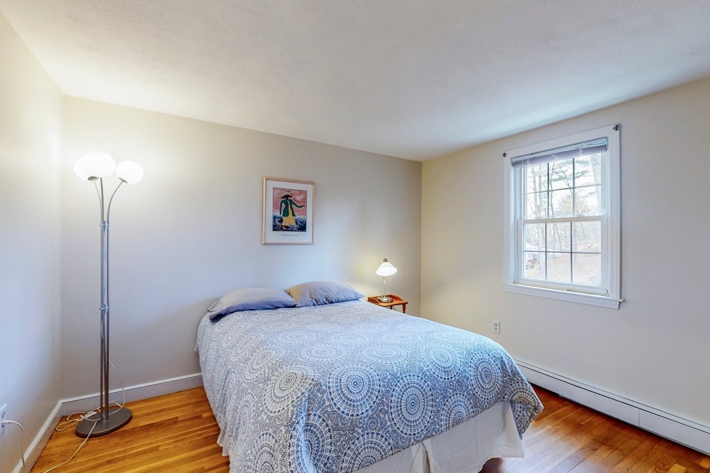 8 Meadowview Road Wayland, MA 01778 - Photo 24 of 40 a bedroom with a bed and wooden floor