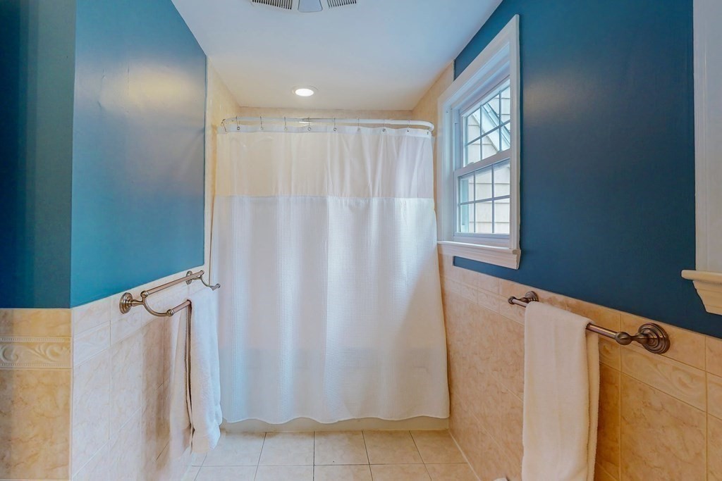 8 Meadowview Road Wayland, MA 01778 - Photo 31 of 40 a view of a bathroom with tub and window