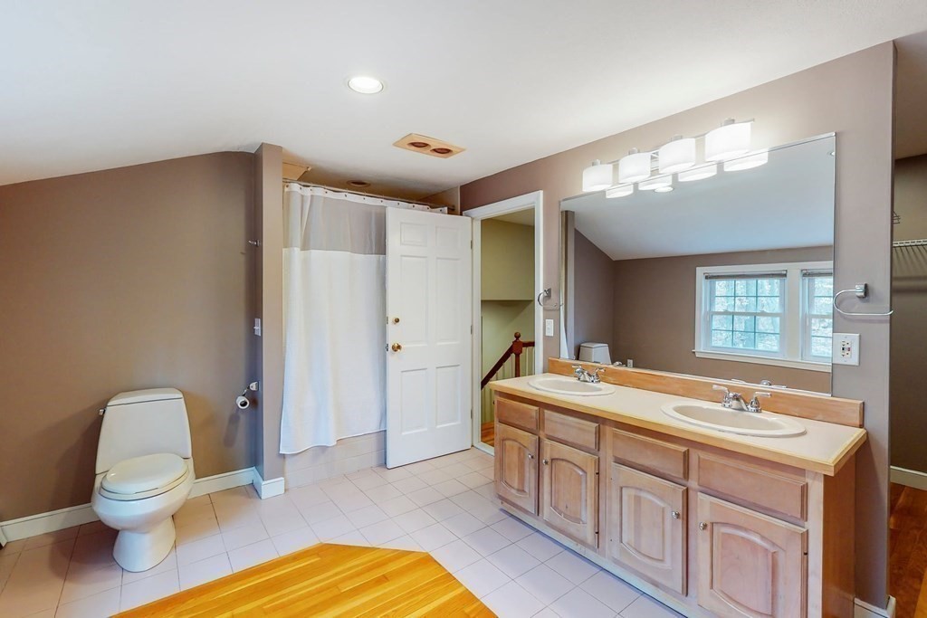8 Meadowview Road Wayland, MA 01778 - Photo 36 of 40 a spacious bathroom with a granite countertop sink and a mirror