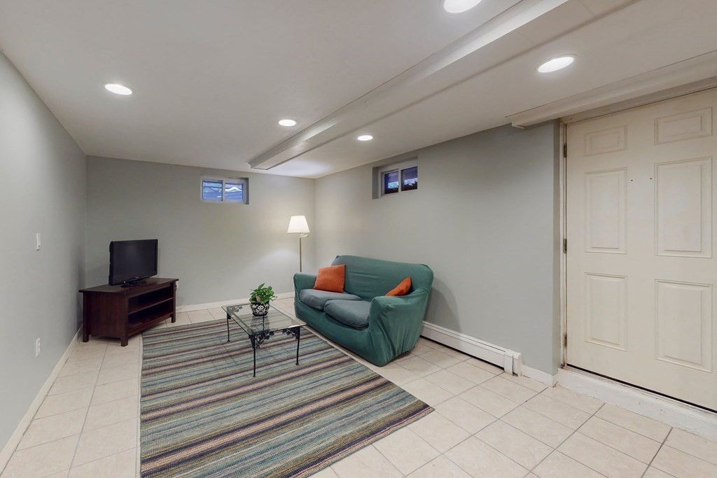 8 Meadowview Road Wayland, MA 01778 - Photo 38 of 40 a living room with furniture and a flat screen tv