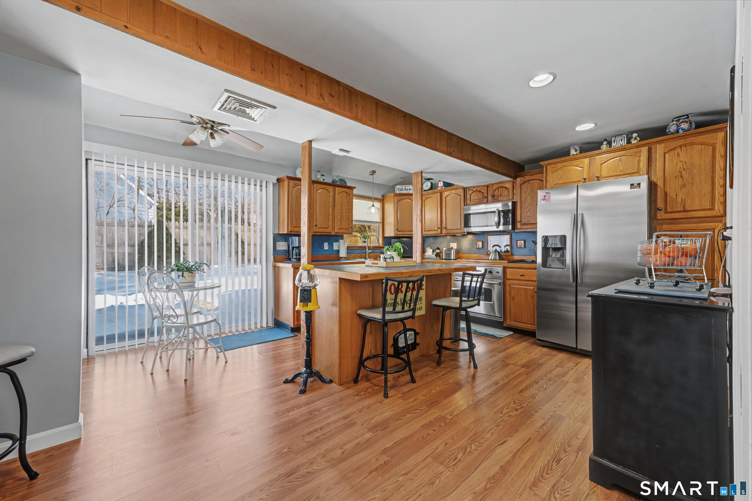 101 Pool Road North Haven, CT 06473 - Photo 4 of 37 a kitchen with stainless steel appliances kitchen island granite countertop a refrigerator a stove a dining table and chairs with wooden floor