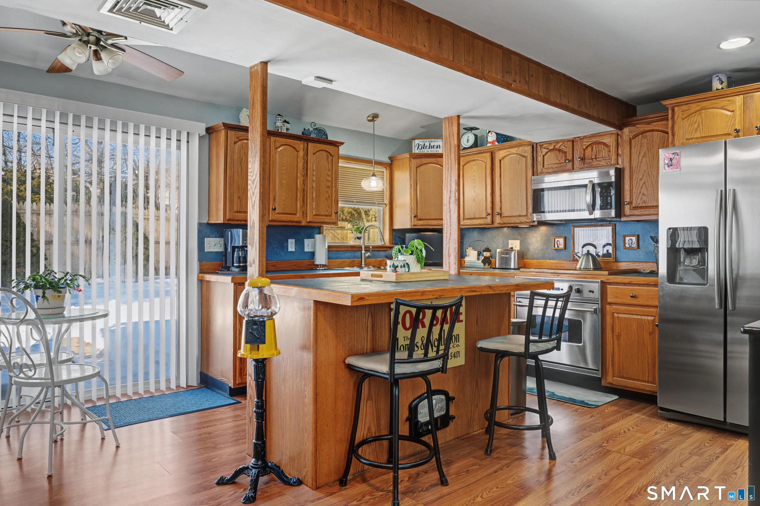 101 Pool Road North Haven, CT 06473 - Photo 5 of 37 a kitchen with stainless steel appliances granite countertop a refrigerator a sink dishwasher a stove and a dining table with wooden floor