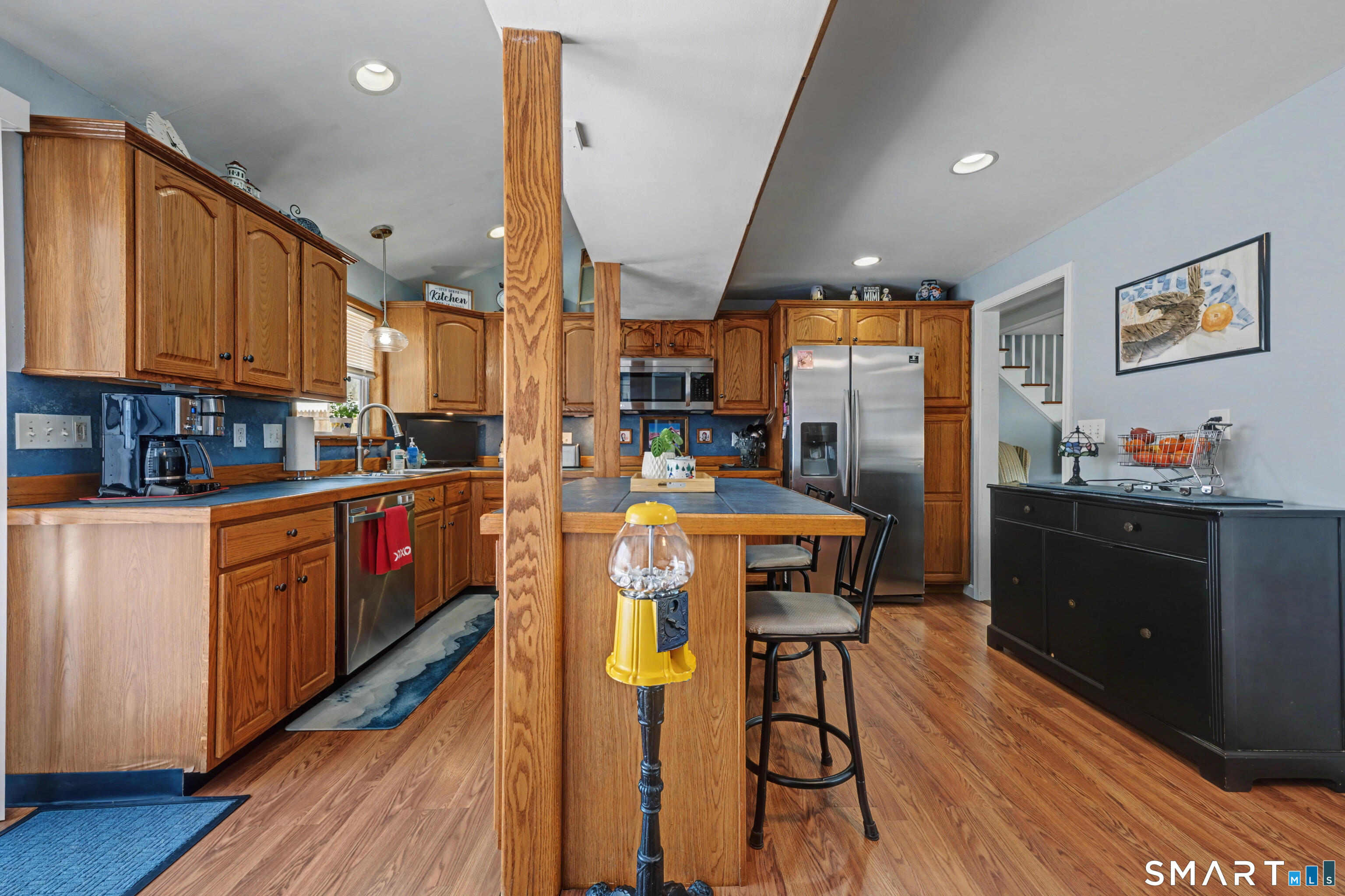 101 Pool Road North Haven, CT 06473 - Photo 8 of 37 a kitchen with stainless steel appliances granite countertop a refrigerator a stove a sink dishwasher and wooden cabinets with wooden floor