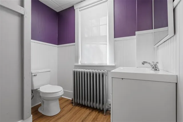 a bathroom with a sink toilet and window