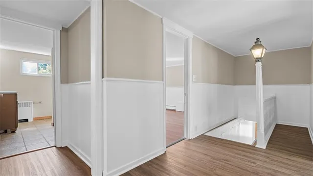 wooden floor in an empty room and a hallway