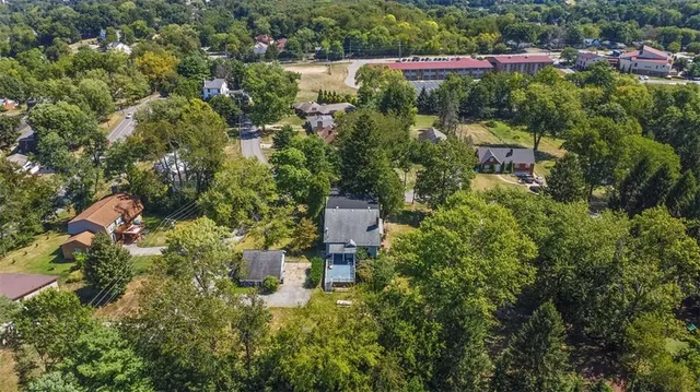 an aerial view of a house with a yard