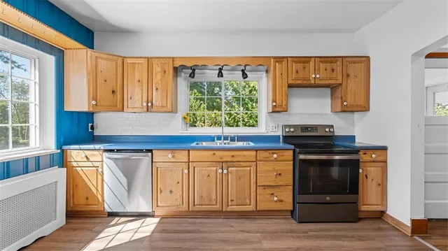 a kitchen with stainless steel appliances granite countertop a stove and a refrigerator