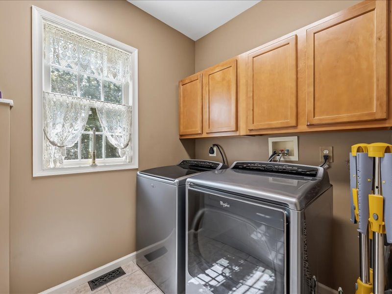 1168 Mt Pleasant Road Bangor, PA 18013 - Photo 59 of 100 Ample wooden cabinetry and modern laundry appliances elevate this functional utility space.