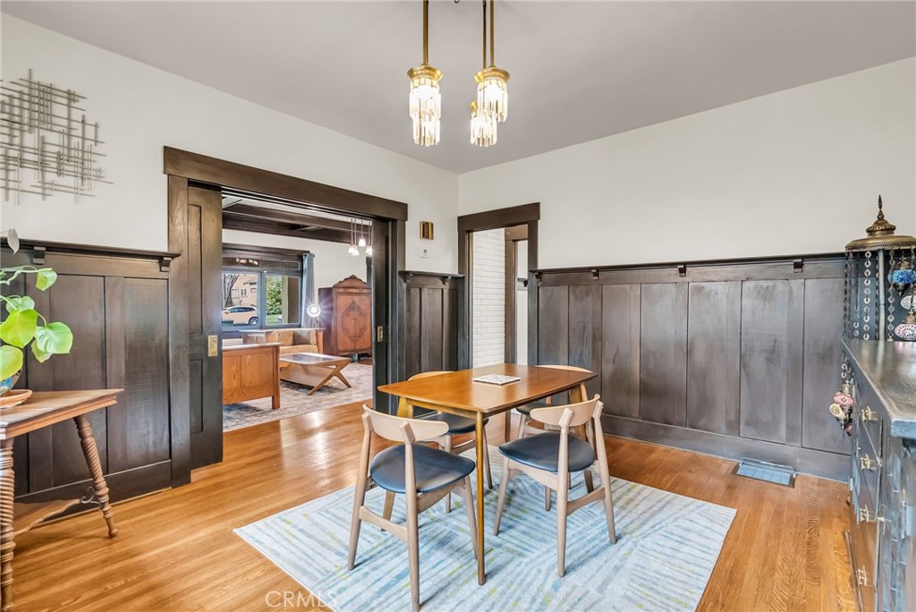 4465 5th Street Riverside, CA 92501 - Photo 12 of 56 a dining room with wooden floor and a chandelier