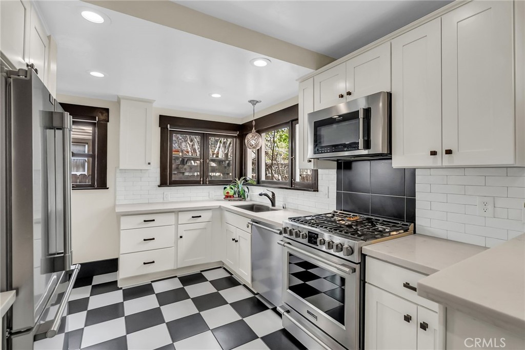 4465 5th Street Riverside, CA 92501 - Photo 16 of 56 a kitchen with stainless steel appliances a stove microwave and cabinets