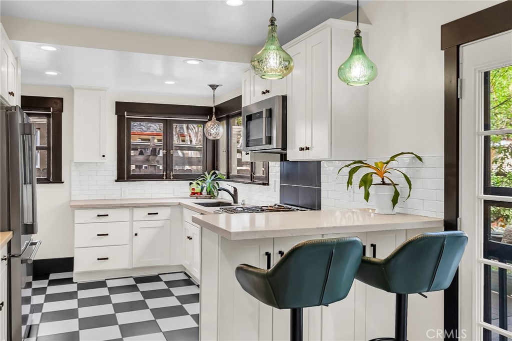 4465 5th Street Riverside, CA 92501 - Photo 20 of 56 a kitchen with granite countertop a sink a center island and cabinets