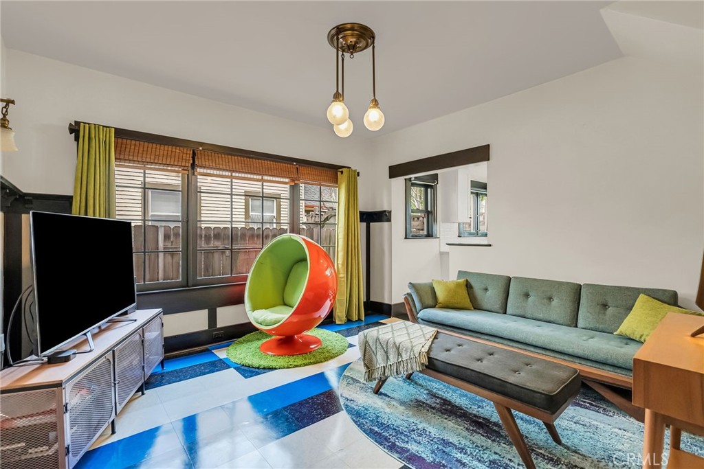 4465 5th Street Riverside, CA 92501 - Photo 23 of 56 a living room with furniture a flat screen tv and a large window